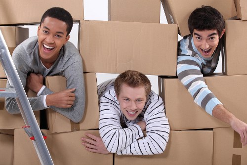 Professional movers transporting office furniture in Selhurst