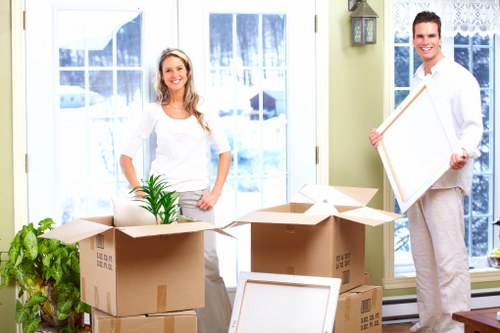 Team packing and protecting furniture for a move