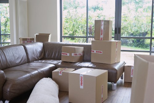Movers transporting furniture through a residential street in Selhurst